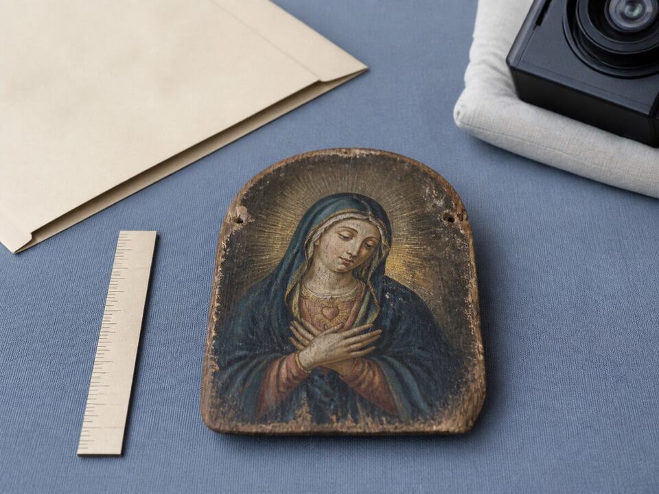 Reading a second-hand listing before you pay: a devotional object arranged on a worktable